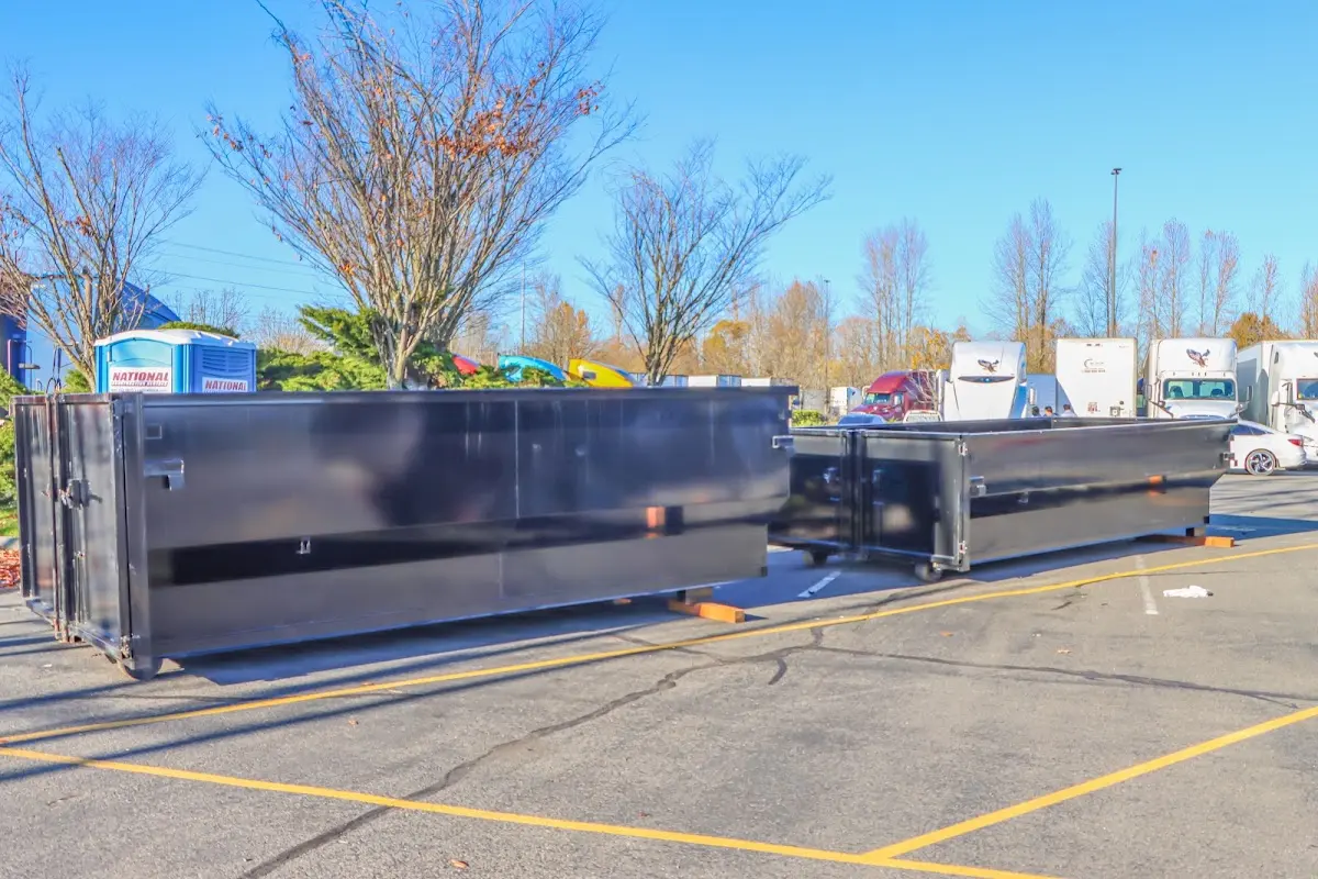 Professional dumpster rental service with roll-off container on residential driveway in Asbury Lake